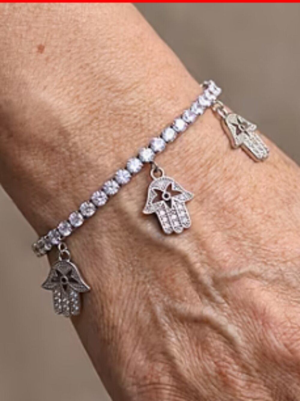 Simulated Diamond Tennis Bracelet with Hamsa Charms in Silvertone